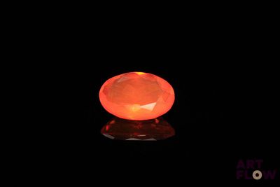 a close up of an orange fire oplite on a black surface