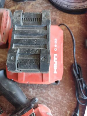 a cordless drill and a cordless hammer on a table