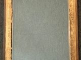 an old picture frame with a blue background and a gold border