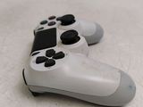 two video game controllers sitting side by side on a table