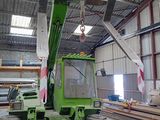a green crane that is sitting in a building