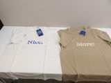 two t - shirts sitting on a table with a price tag