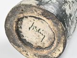 a close up of a vase with writing on it