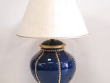 a blue lamp with a white shade on it