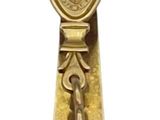 brass bell with a coat of arms and a cross on it