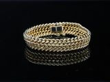 a gold bracelet on a black surface