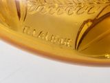 a close up of a gold spoon on a white table