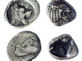 four silver coins with a picture of a man and a woman on them