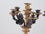 a black and gold candelier with five candles on it