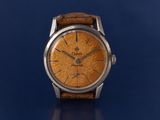 an image of a watch on a blue surface