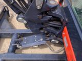 a close up of a fork and a fork lifter on a vehicle