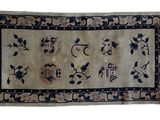 an old rug with blue and white flowers on it