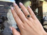 an image of a woman ' s hand with a ring on it