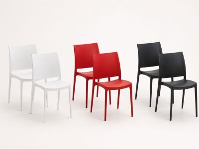 four different colored chairs are arranged in a row on a white surface