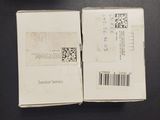 two boxes that are sitting on a table with a barcode on them