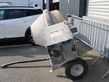 a cement mixer that is sitting in the parking lot