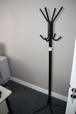 an image of a coat rack in the corner of a room