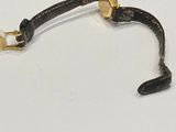 an image of a black leather bracelet with a gold clasp