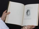 a person holding an open book with a picture on it
