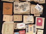 a lot of old papers and old stamps on a table