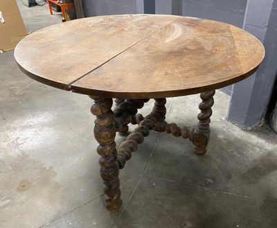 an old table with a wooden top and wooden legs