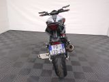 a motorcycle that is parked in a room with a checkered floor