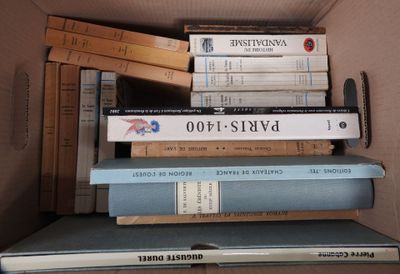 many books stacked on top of each other in a box