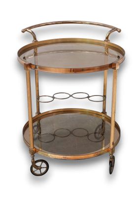 an antique brass bar cart with glass shelves and wheels