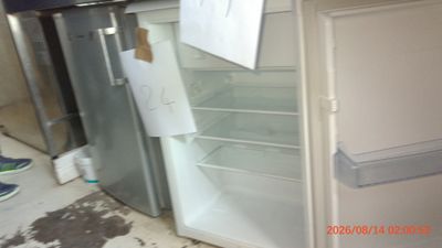 a refrigerator that has a lot of papers on the door
