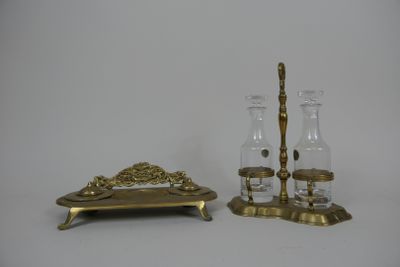 two glass vases and a candle holder on a table