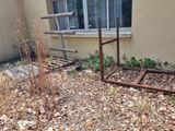 a broken window frame sitting in the middle of a yard