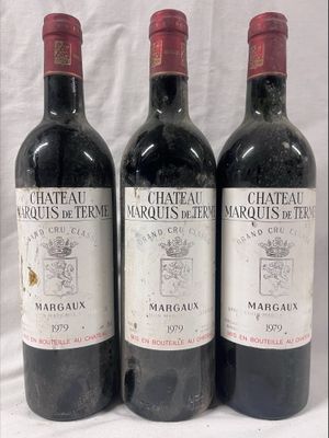 three bottles of red wine are lined up on a table