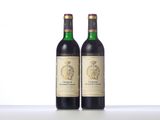 two bottles of wine sitting on top of a table next to each other