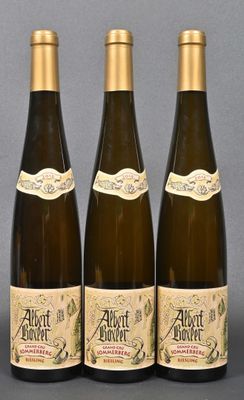 three bottles of wine sitting on top of a table next to each other
