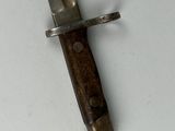 a knife that is laying on a white surface