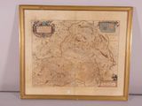 an old map of england in a gold frame on a wall