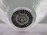 a close up of a glass vase with a black and white design