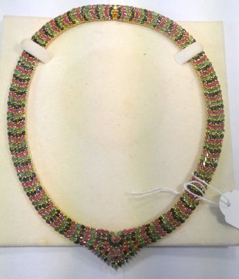 a close up of a necklace on a white surface
