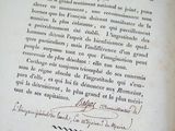 an old book with a handwritten text on it sitting on a table