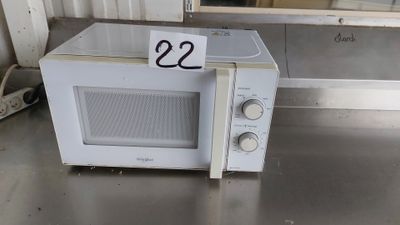 a white microwave sitting on a table with a price tag on it