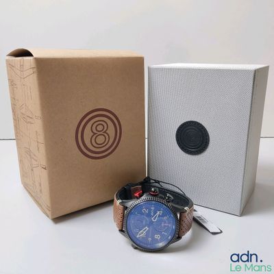 a watch sitting next to a box with a watch in it