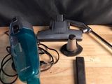 Quelqu'un utilise un aspirateur pour nettoyer une table en bois.