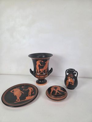 four pieces of pottery on a white surface