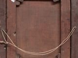 an old wooden frame with a rope hanging from it