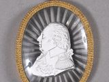 a close up of a silver and gold locke with a picture of a man