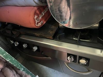 a metal pan sitting on top of a stove in a kitchen