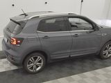 the rear end of a gray volkswagen suv parked in a garage