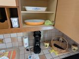 a small kitchen with a stove, sink, microwave, and dishwasher