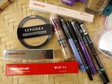 many different makeup products on the table together