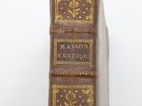 an old book sitting on top of a white surface